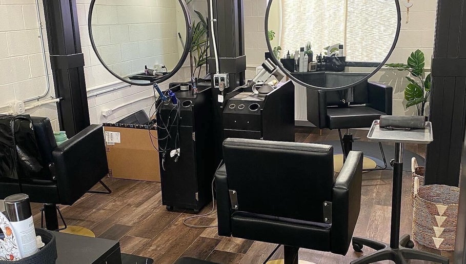 Modern salon station at Tristen Graves, Ridgefield, Washington, US with sleek black chairs and mirrors.
