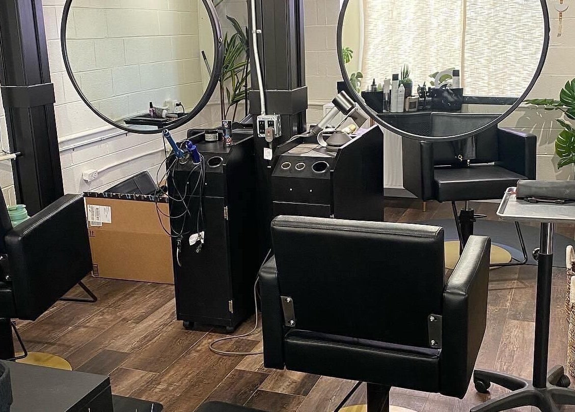 Modern salon interior at Tristen Graves, Ridgefield, Washington, US, featuring sleek black chairs and mirrors.