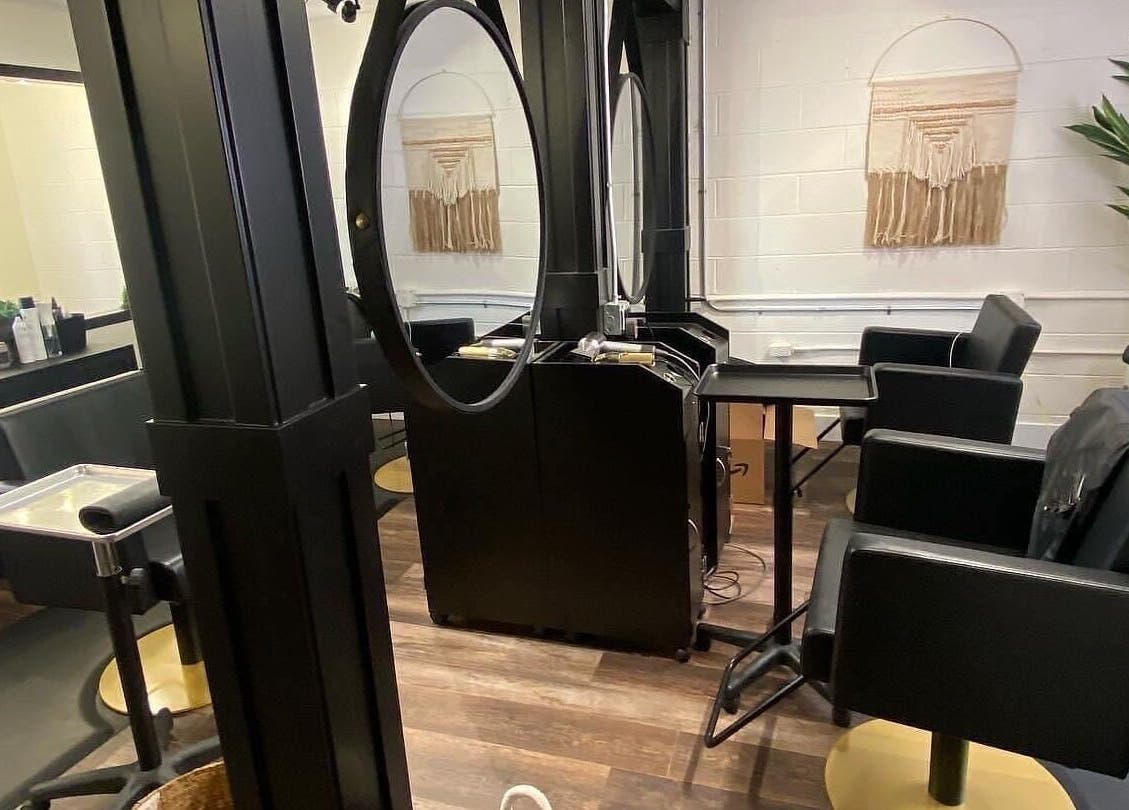 Modern salon interior at Tristen Graves in Ridgefield, Washington, US with stylish black chairs and decor.