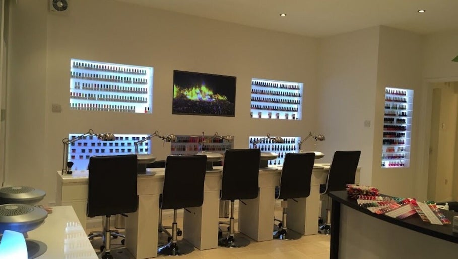 Modern nail salon interior at The Nail Boutique, Hersham, England, GB featuring sleek design and vibrant polish displays.