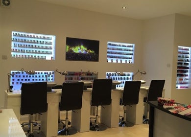 Modern nail salon interior at The Nail Boutique, Hersham, England, GB featuring sleek design and vibrant polish displays.