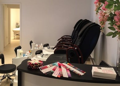 The Nail Boutique in Hersham, England, GB, showcasing modern pedicure stations and colorful nail polish collection.