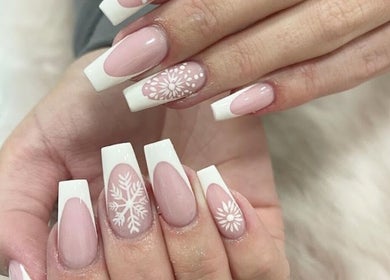 Intricate nail design at The Nail Boutique, Hersham, England, GB with white floral patterns.