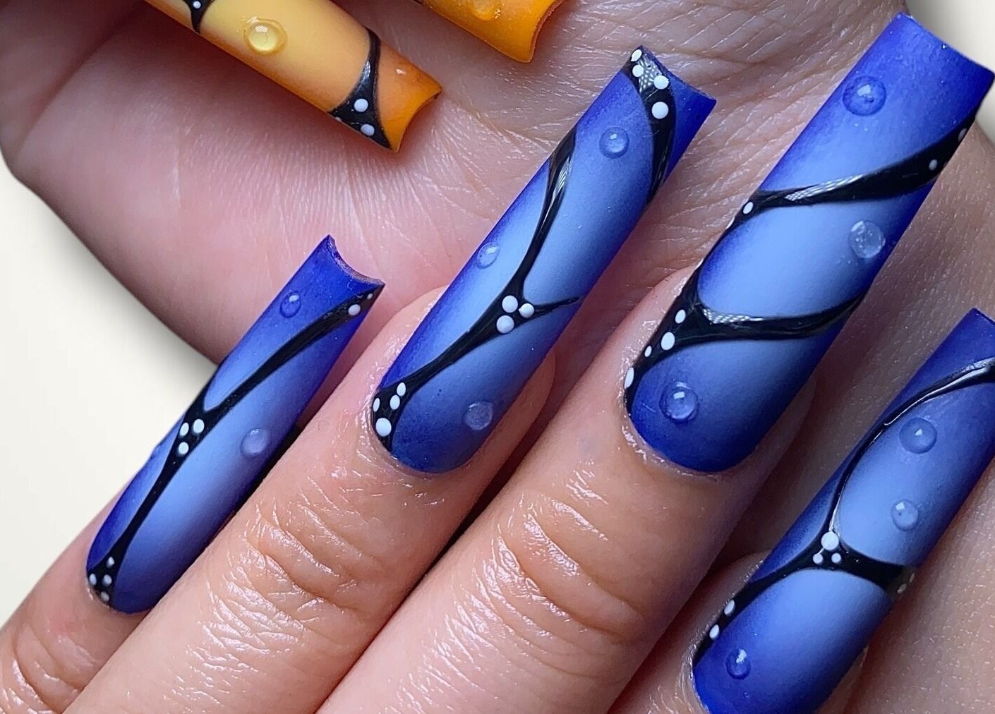 Intricate blue and orange nail art design at Nails By Bonn in Walnut Creek, California, US.