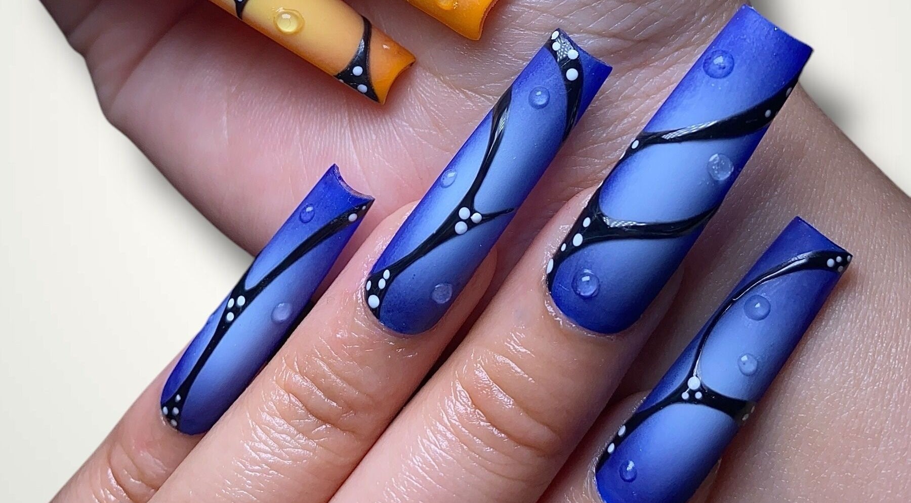 Intricate blue and orange nail art design at Nails By Bonn in Walnut Creek, California, US.