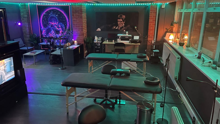 Modern tattoo studio at MJ ink tattoos, Barking, England, GB with ambient lighting and artistic decor.