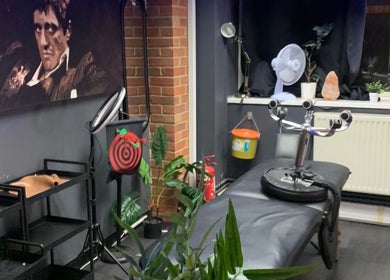 Comfortable tattoo station at MJ ink tattoos in Barking, England, GB, with unique decor and ambient lighting.