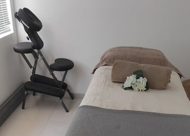 Relaxing spa room at Clarify wellness spa in Johannesburg, Gauteng, ZA with massage chair and table.
