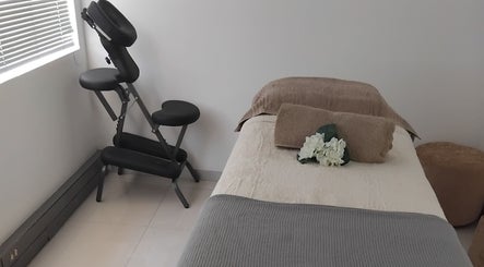 Massage room at Clarify wellness spa, Johannesburg, Gauteng, ZA with a comfy bed and massage chair.