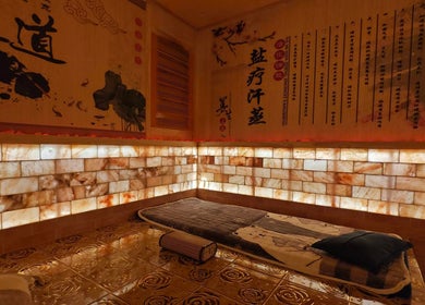 Cozy salt therapy room at AiRelax® Spa, Auckland, Auckland, NZ, with Himalayan salt walls and elegant decor.
