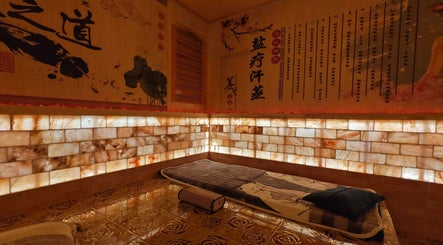 Cozy salt therapy room at AiRelax® Spa, Auckland, Auckland, NZ, with Himalayan salt walls and elegant decor.