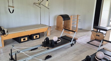 Pilates equipment at Pilates@The Honey Homestead, Piggabeen, New South Wales, AU. Inviting wellness space.