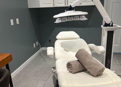 Treatment room at YOSHIDA BEAUTY CLINIC【Broadway Location】, Vancouver, BC, featuring a therapeutic chair.