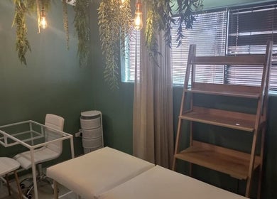 Relaxing treatment room at Radiant Grace Wellness & Beauty Bar, Mossel Bay, Western Cape, ZA with greenery accents.