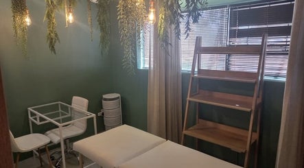 Relaxing treatment room at Radiant Grace Wellness & Beauty Bar, Mossel Bay, Western Cape, ZA with greenery accents.