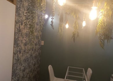 A tranquil spa room at Radiant Grace Wellness & Beauty Bar, Mossel Bay, Western Cape, ZA with hanging greenery.