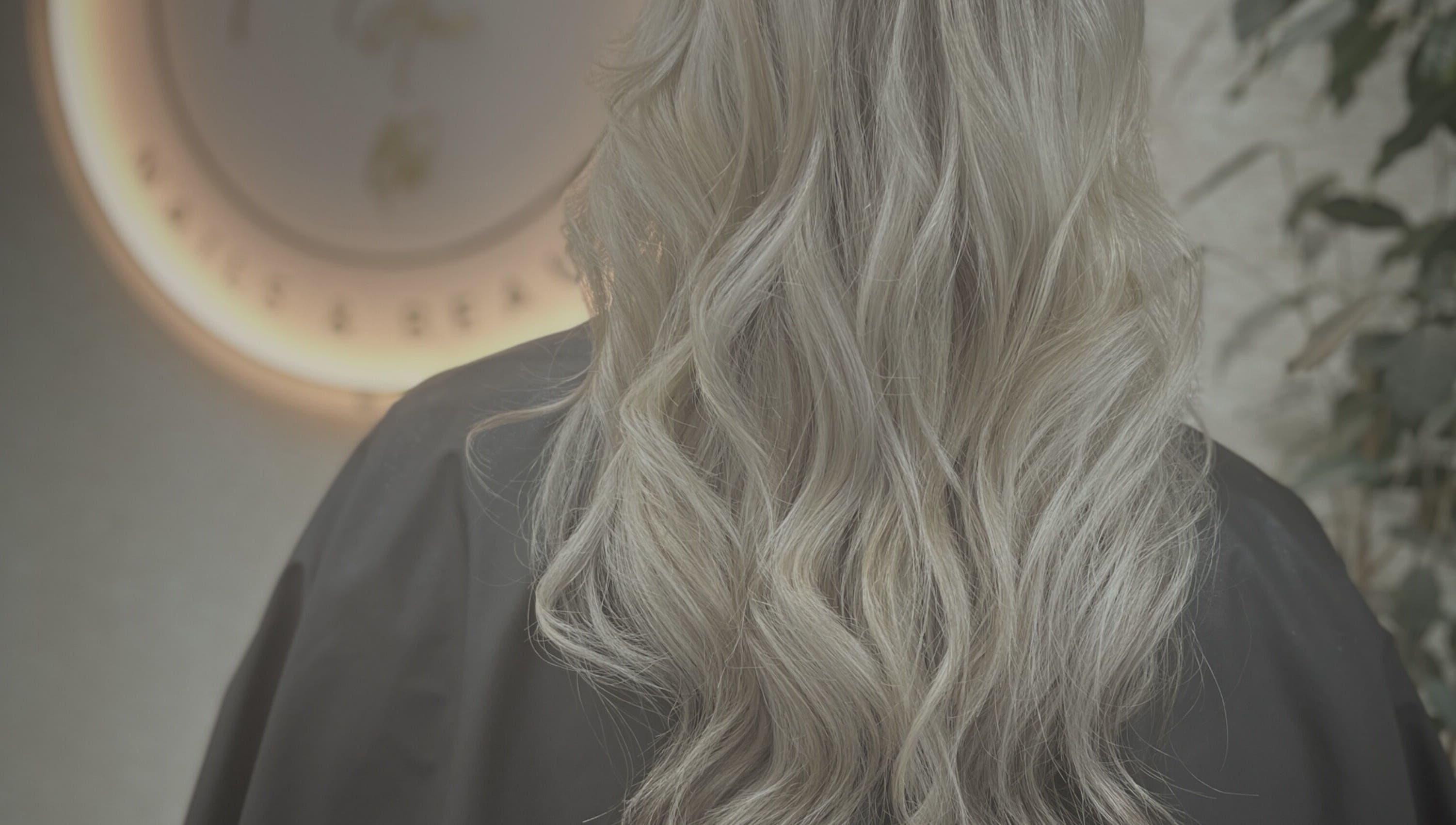 Elegant blonde waves styled at CaraEvans_Hair, Milford Haven, Wales, GB in a chic salon ambiance.