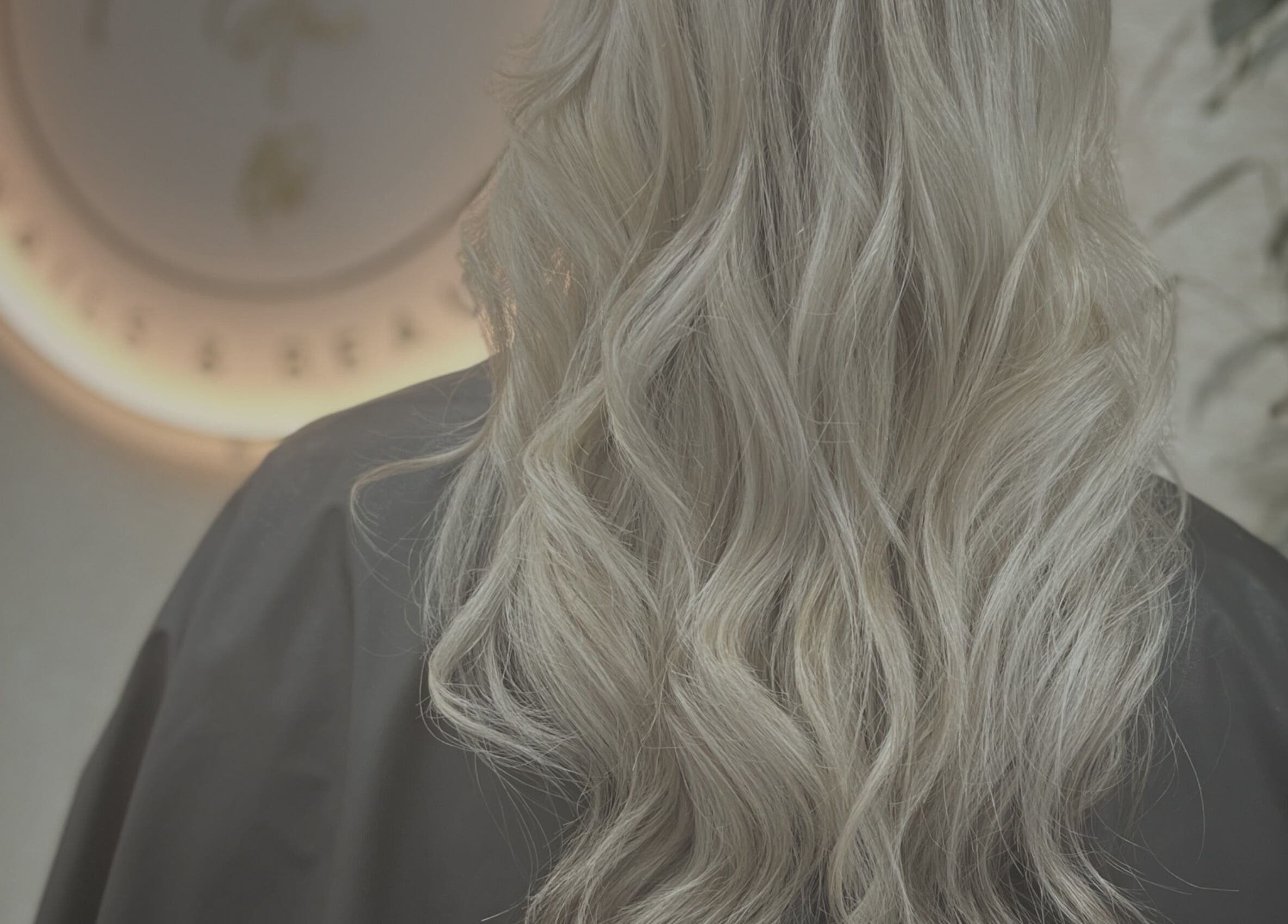 Elegant blonde waves styled at CaraEvans_Hair, Milford Haven, Wales, GB in a chic salon ambiance.