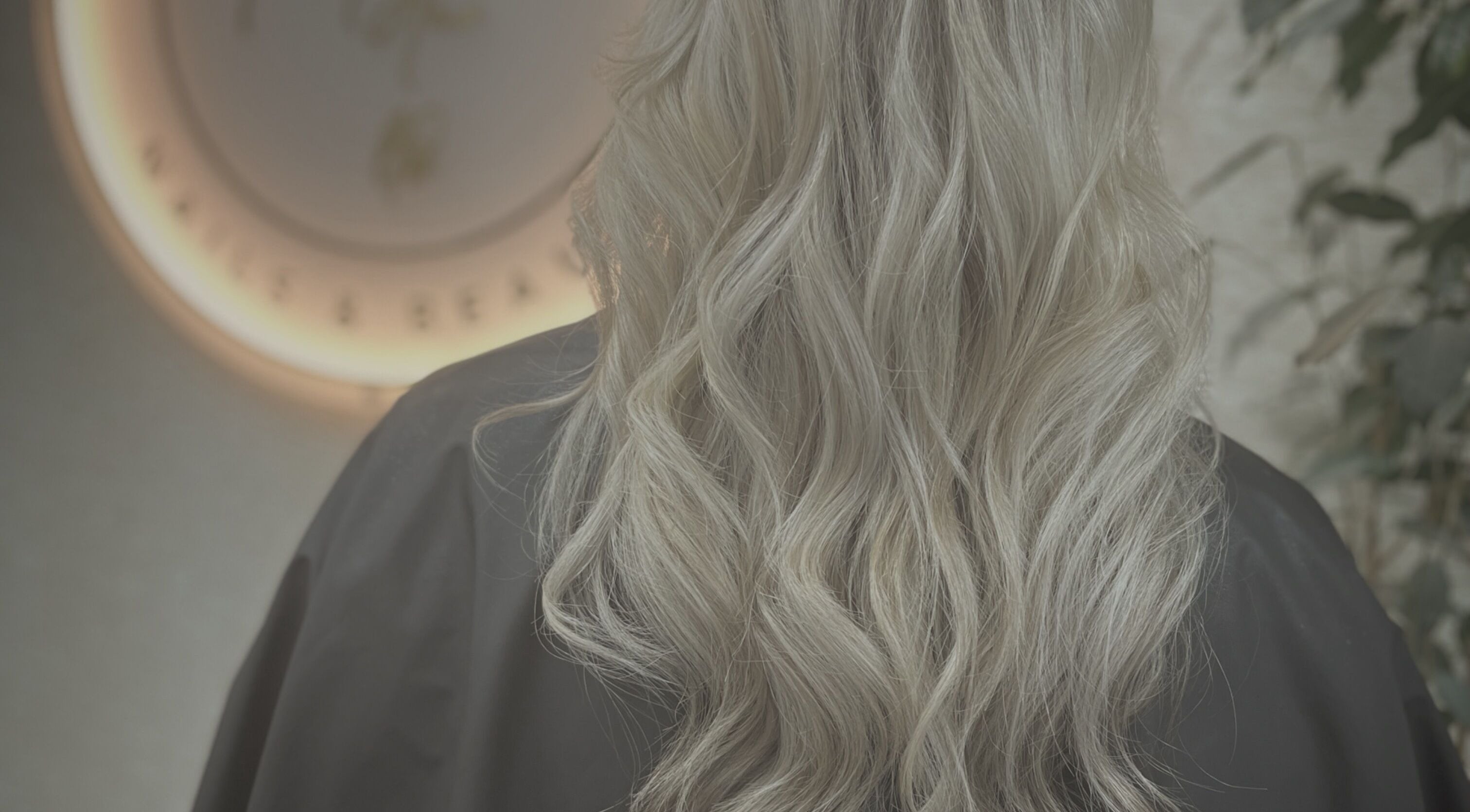 Elegant blonde waves styled at CaraEvans_Hair, Milford Haven, Wales, GB in a chic salon ambiance.