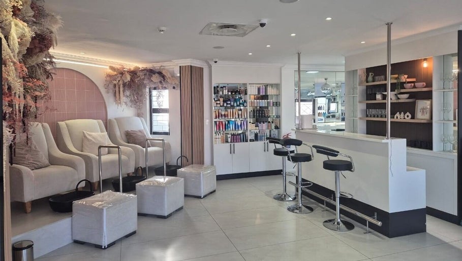 Interiors of Blush Aesthetics & Beauty Bar, Cape Town, Western Cape, ZA; elegant seating and beauty products.