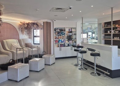 Interiors of Blush Aesthetics & Beauty Bar, Cape Town, Western Cape, ZA; elegant seating and beauty products.