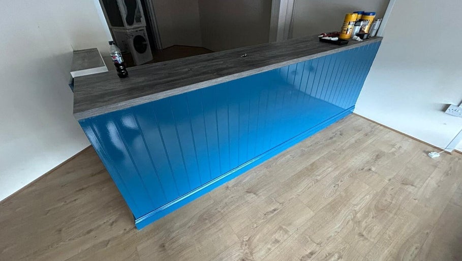 Reception area at Shampooched, featuring a blue counter in Croydon, England, GB.