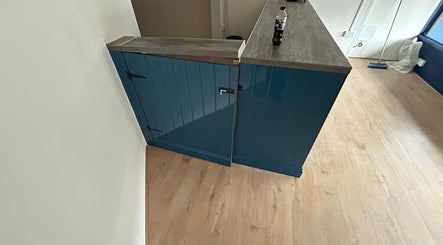 Stylish blue reception counter at Shampooched, Croydon, England, GB platforming a chic wooden finish.