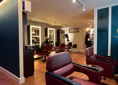 Henko Studio salon interior in London, England, GB showcasing modern chairs and styling stations.