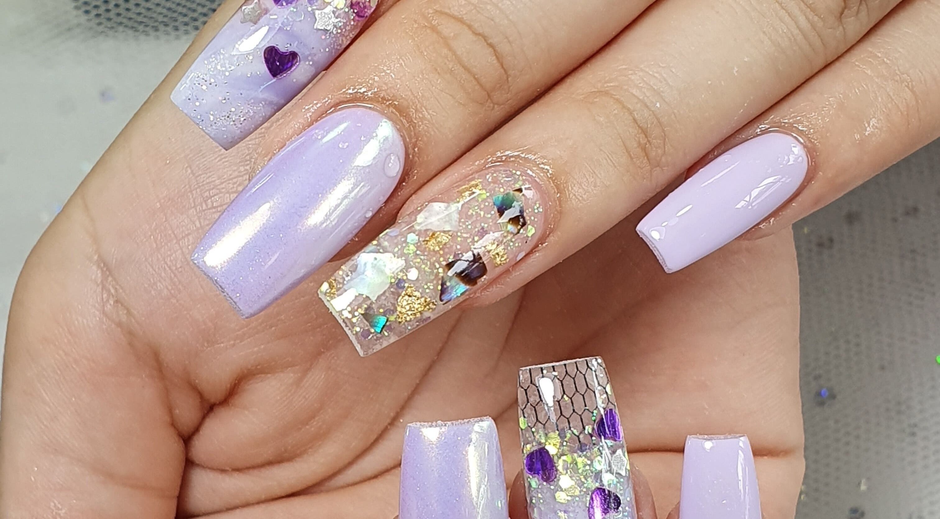 Close-up of lavender nail art with glitter at Sandy Nails And Headspa Therapy, Cabramatta, New South Wales, AU.