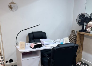 Modern manicure station at Ella’s Beauty Lounge, Briercliffe, England, GB, featuring sleek black chairs and nail tools.
