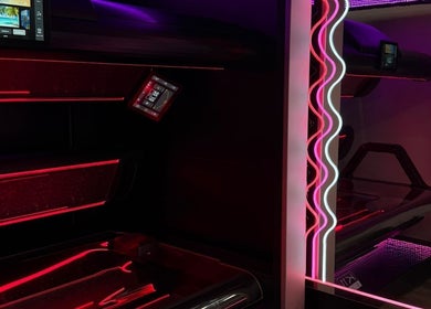 State-of-the-art tanning bed at Glow Up Tanning & Beauty Downham, Downham Market, England, GB, featuring vibrant neon lights.