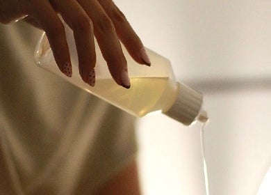 Hand pouring oil at Glow Up Tanning & Beauty Downham, Downham Market, England, GB for relaxation treatments.