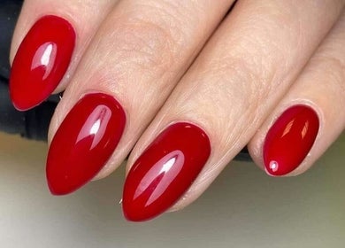 Vibrant red manicured nails at Blush Beauty And Nails, Bathgate, Scotland, GB.