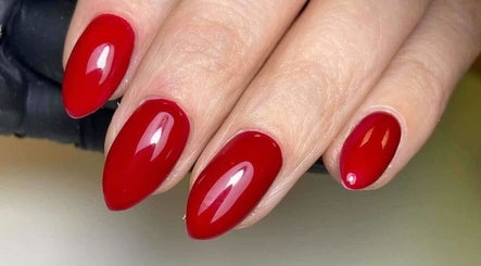Vibrant red manicured nails at Blush Beauty And Nails, Bathgate, Scotland, GB.