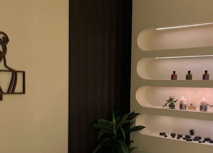 زاوية الاسترخاء في Shea Salon Spa & Beauty، مكة، تحقق تجربة هادئة مع الشموع والنباتات في أرفف جمالية.