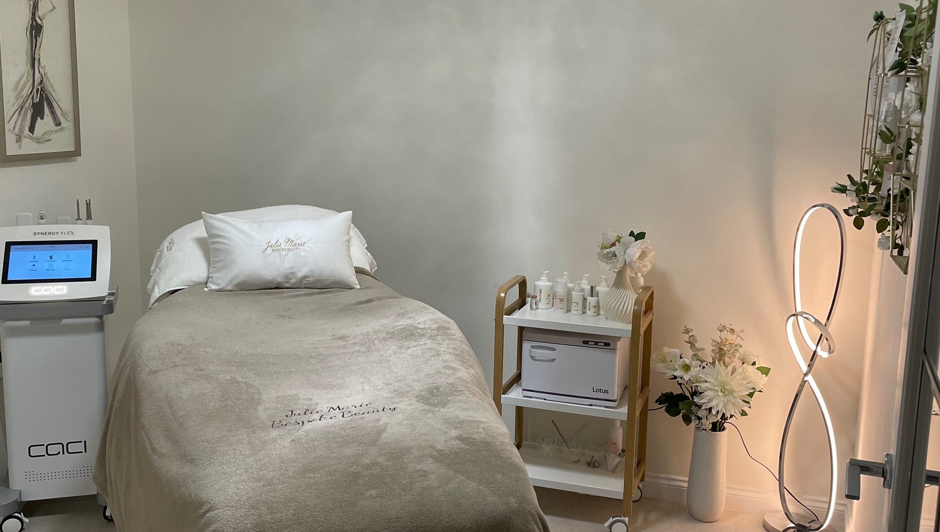 Tranquil treatment room at Julie Marie Bespoke Beauty, Dunbar, Scotland, GB with sleek CACI machine.
