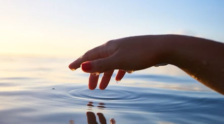 Calm hand touching water at The Mind Mend Therapy, Wickham, England, GB for tranquility and wellness.