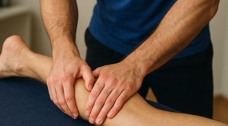 Massage therapy session at Glo & Co in Wallingford, England, GB, showcasing skilled hands working on a leg.