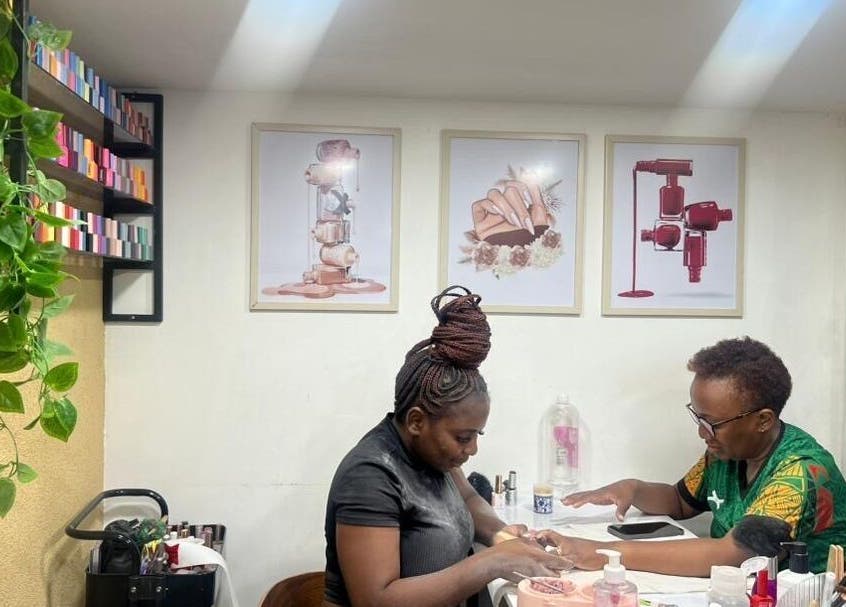 A technician working on a client's nails at Valued Nails, Lusaka, Lusaka Province, ZM. Inviting and professional.