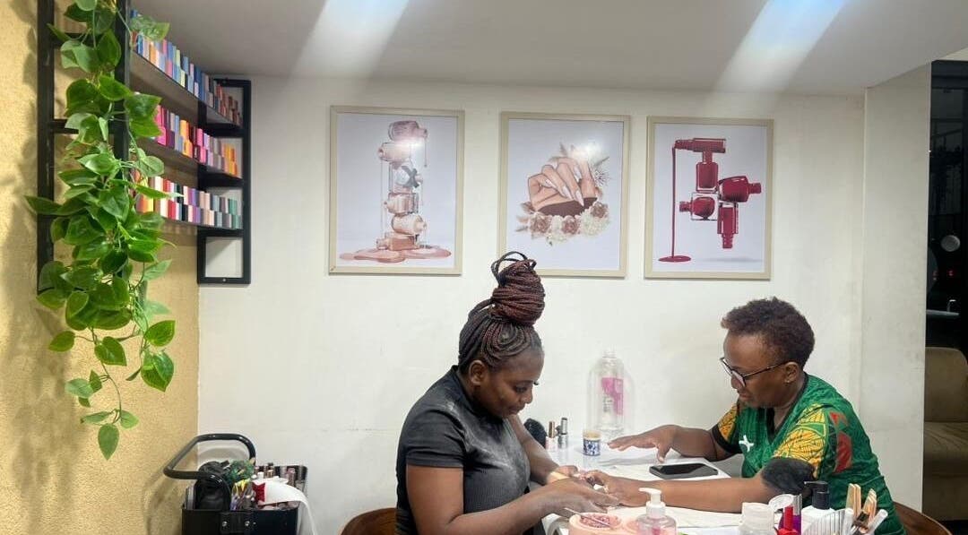 A technician working on a client's nails at Valued Nails, Lusaka, Lusaka Province, ZM. Inviting and professional.