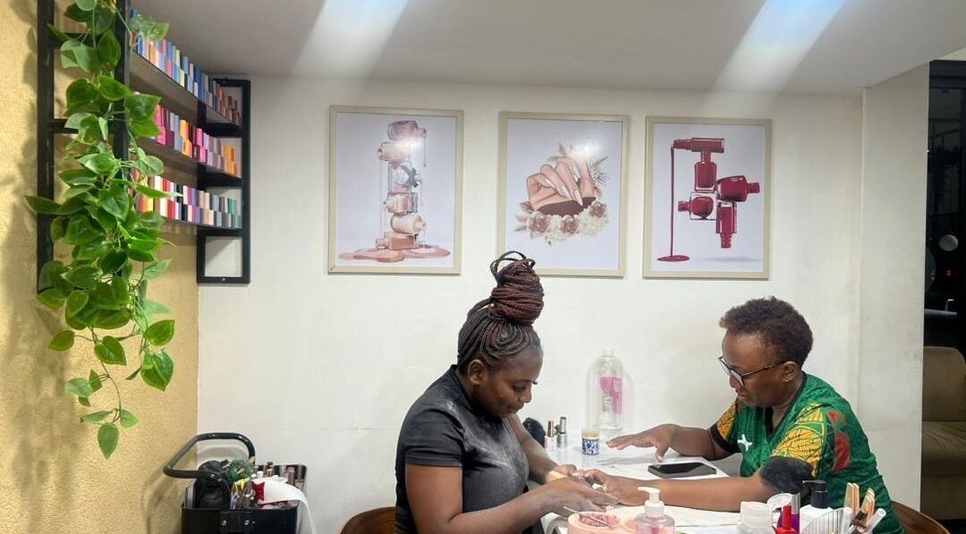 A technician working on a client's nails at Valued Nails, Lusaka, Lusaka Province, ZM. Inviting and professional.