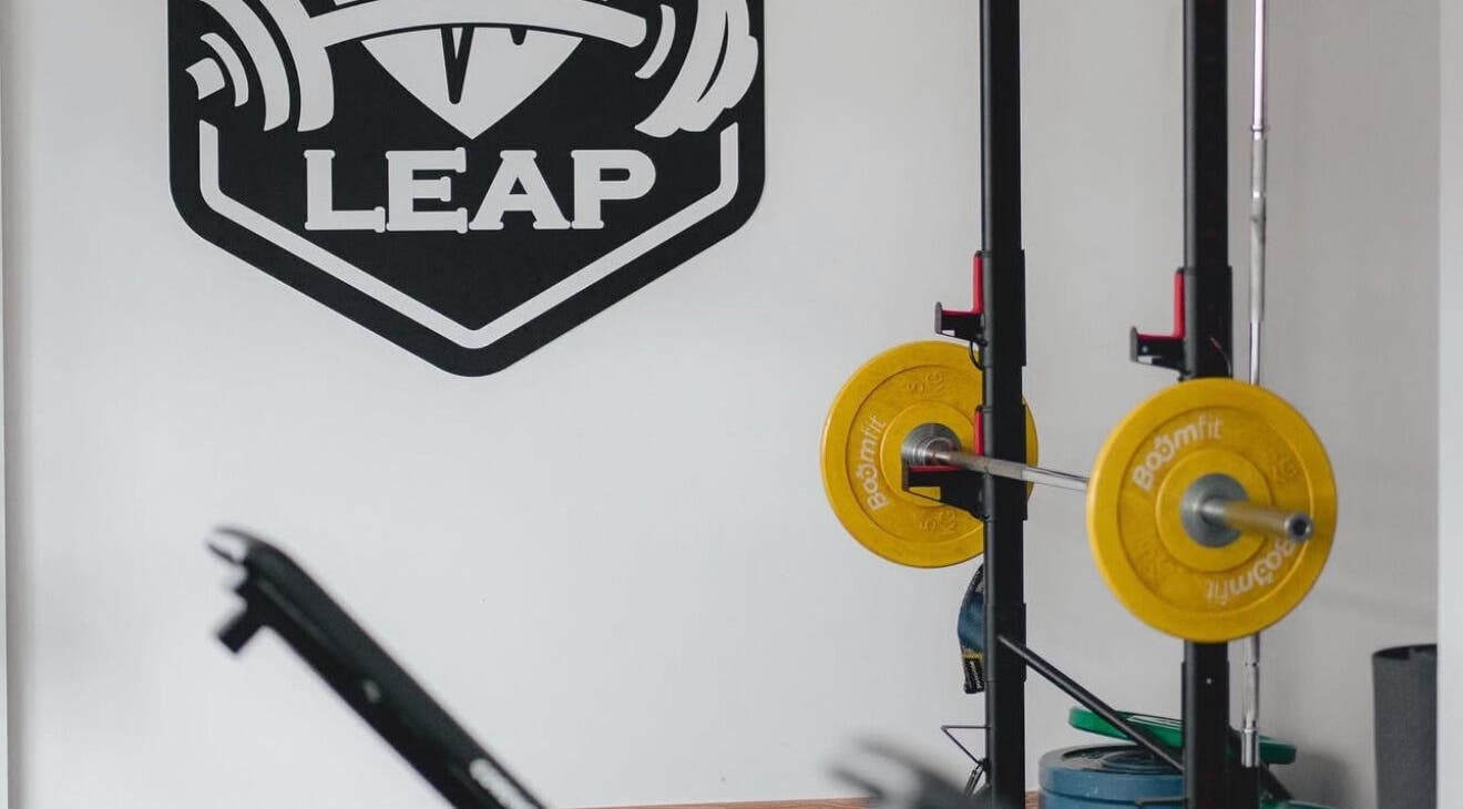 LEAP-FITNESS STUDIO weightlifting setup in Ramada, Lisboa, PT, featuring yellow weights and gym equipment.