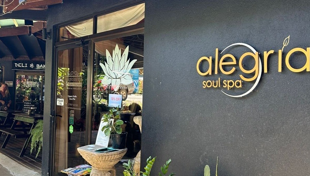 Entrance of Alegria Soul Spa in Puntarenas Province, CR, featuring stylish signage and leafy decor.