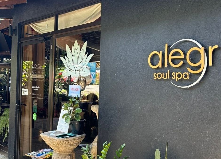 Entrance of Alegria Soul Spa in Puntarenas Province, CR, featuring stylish signage and leafy decor.
