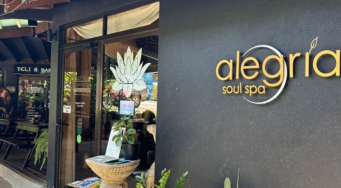 Entrance of Alegria Soul Spa in Puntarenas Province, CR, featuring stylish signage and leafy decor.