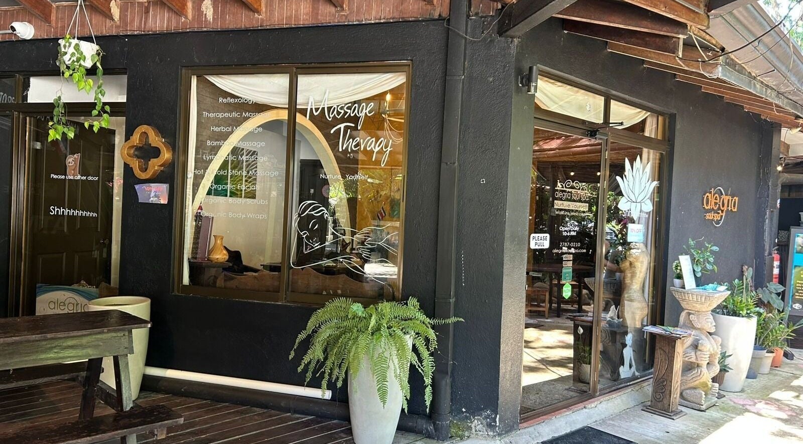 Entrance of Alegria Soul Spa, Puntarenas, featuring massage therapy signage and inviting decor.