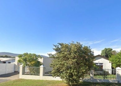 Exterior of Skin and Body Fitness Table View, Cape Town, Western Cape, ZA, featuring lush greenery and fencing.