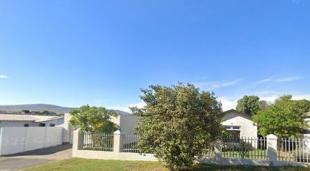 Skin and Body Fitness Table View in Cape Town, Western Cape, ZA surrounded by lush greenery and clear blue sky.