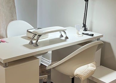 Modern nail treatment station at NailedbyNehita in Toronto, Ontario, CA, featuring sleek white design.