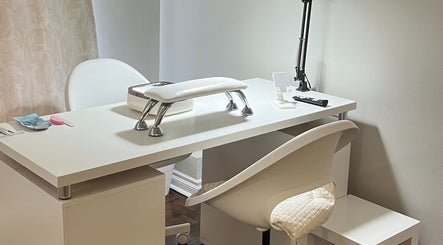 Modern nail treatment station at NailedbyNehita in Toronto, Ontario, CA, featuring sleek white design.
